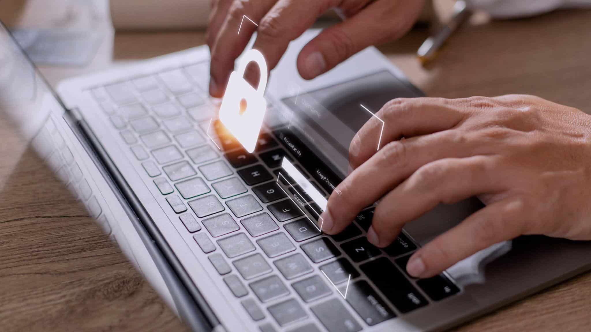A laptop keyboard with a lock and login projected above depicting cybersecurity.