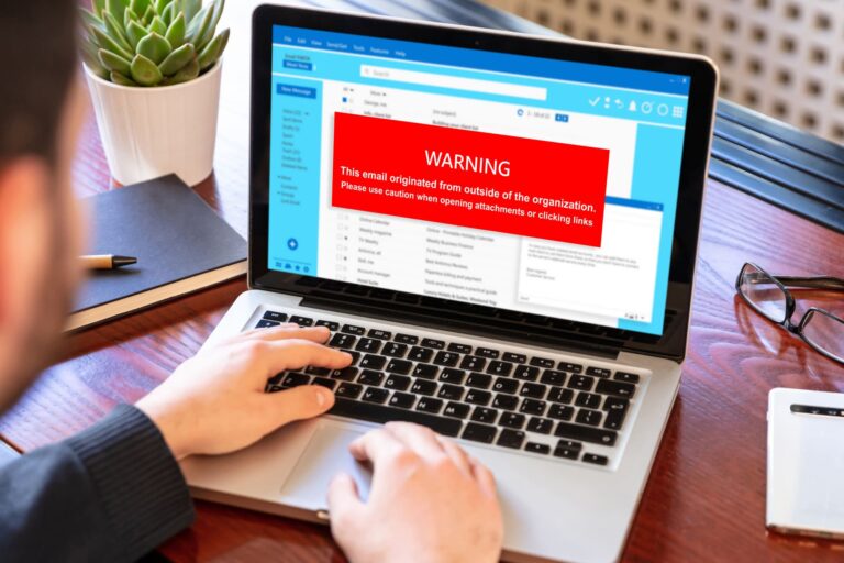 Warning message about suspicious email on laptop screen