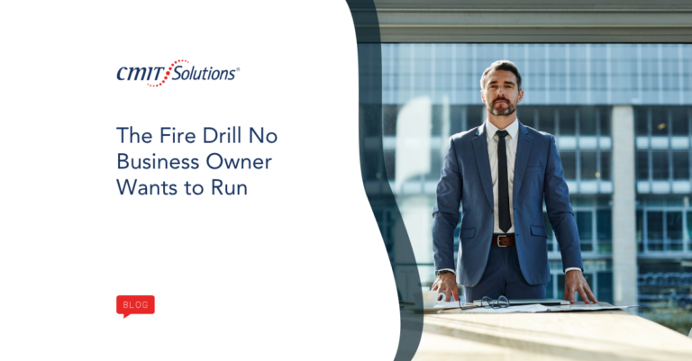 CMIT Solutions blog hero: a man in a blue suit stands at a desk outdoors with the headline 'The Fire Drill No Business Owner Wants to Run' and the CMIT Solutions logo nearby.