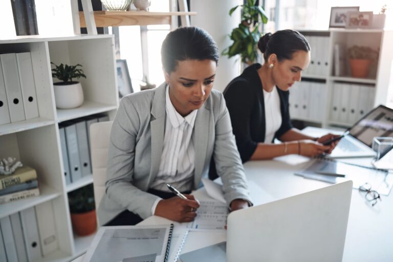 cropped-shot-of-two-attractive-young-businesswomen