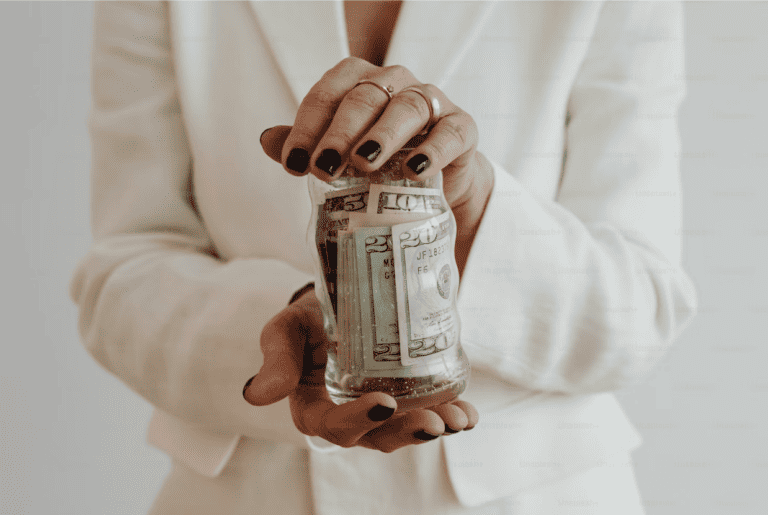 woman holding jar of money