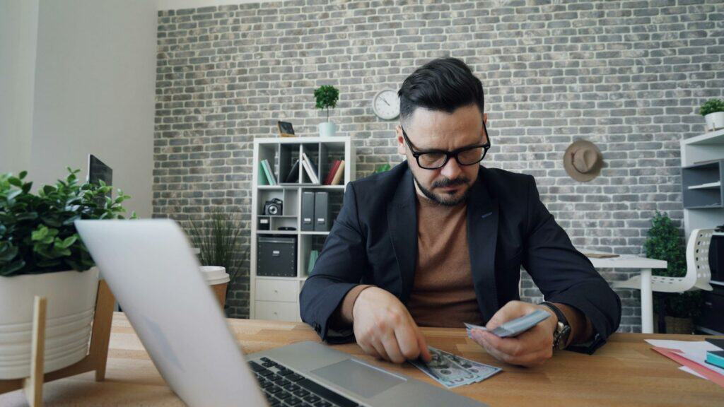Accountant working at a laptop in a small office