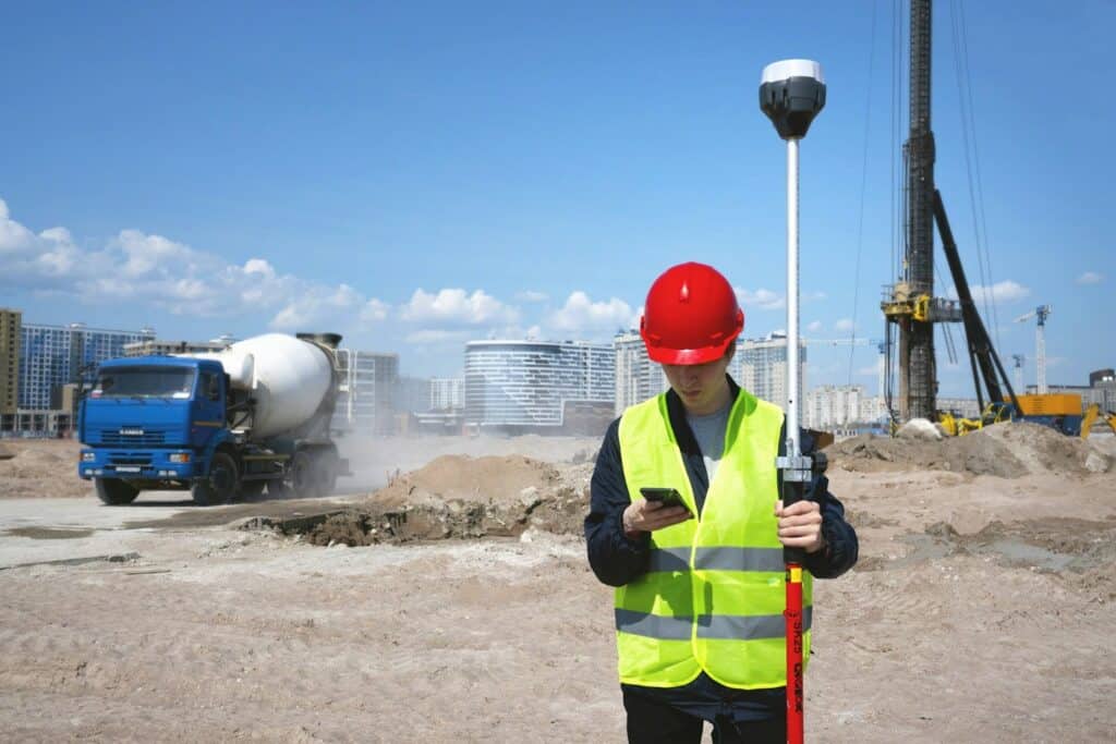 Construction worker using a mobile device on a job site