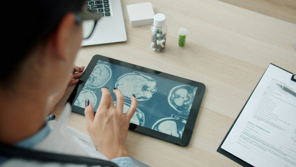 Doctor reviewing medical scans on a tablet