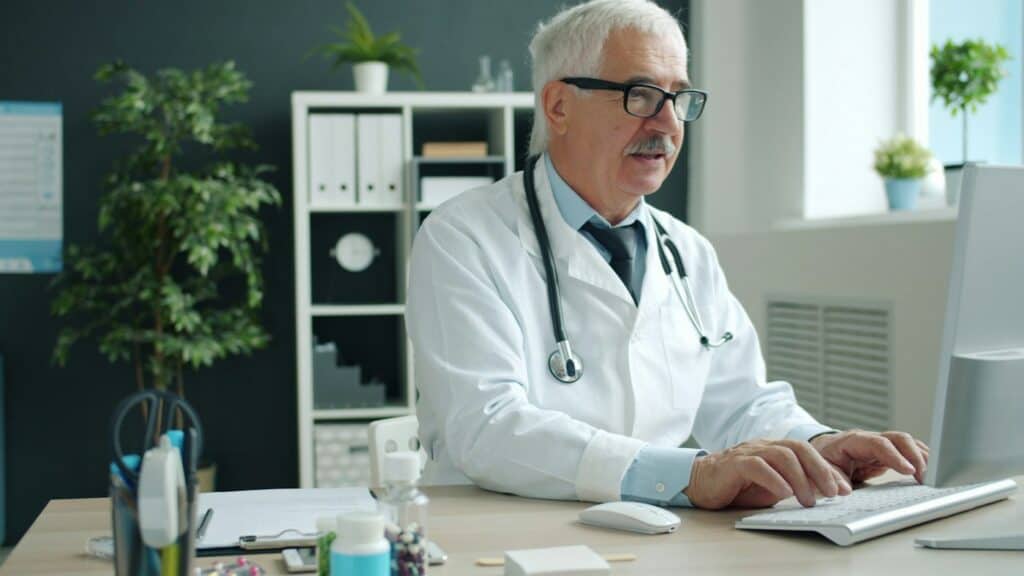 Doctor typing on a computer in a medical office