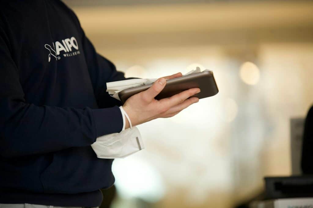 Employee holding a smartphone used for work