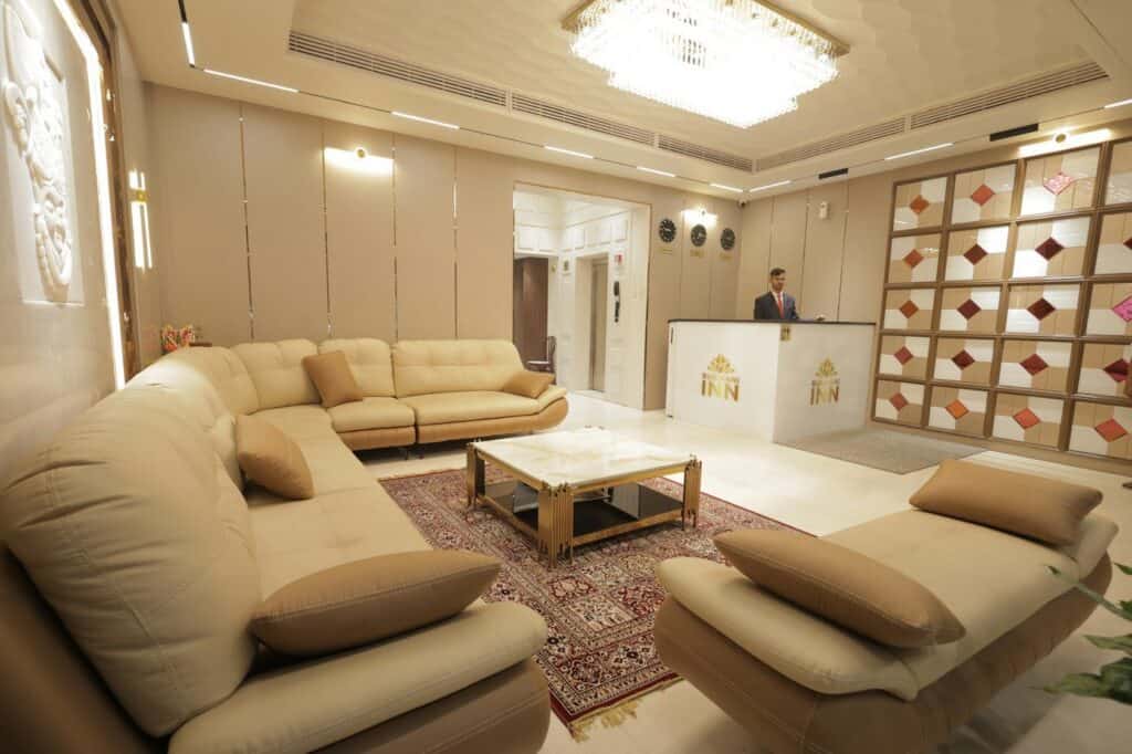 Hotel lobby with a reception desk and guest seating area