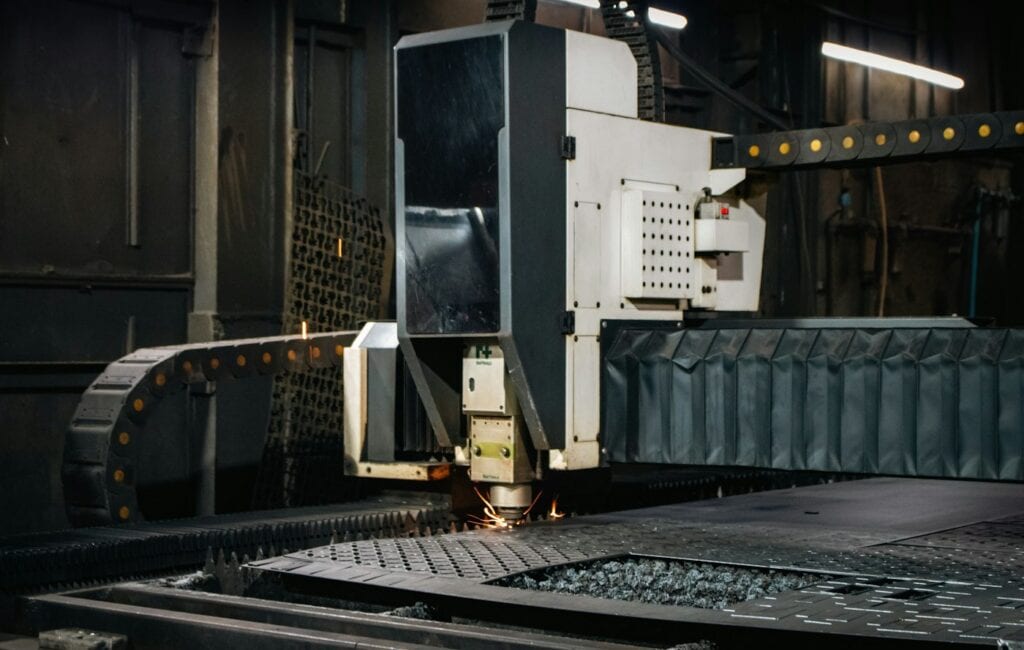 Industrial laser cutter working on a metal sheet