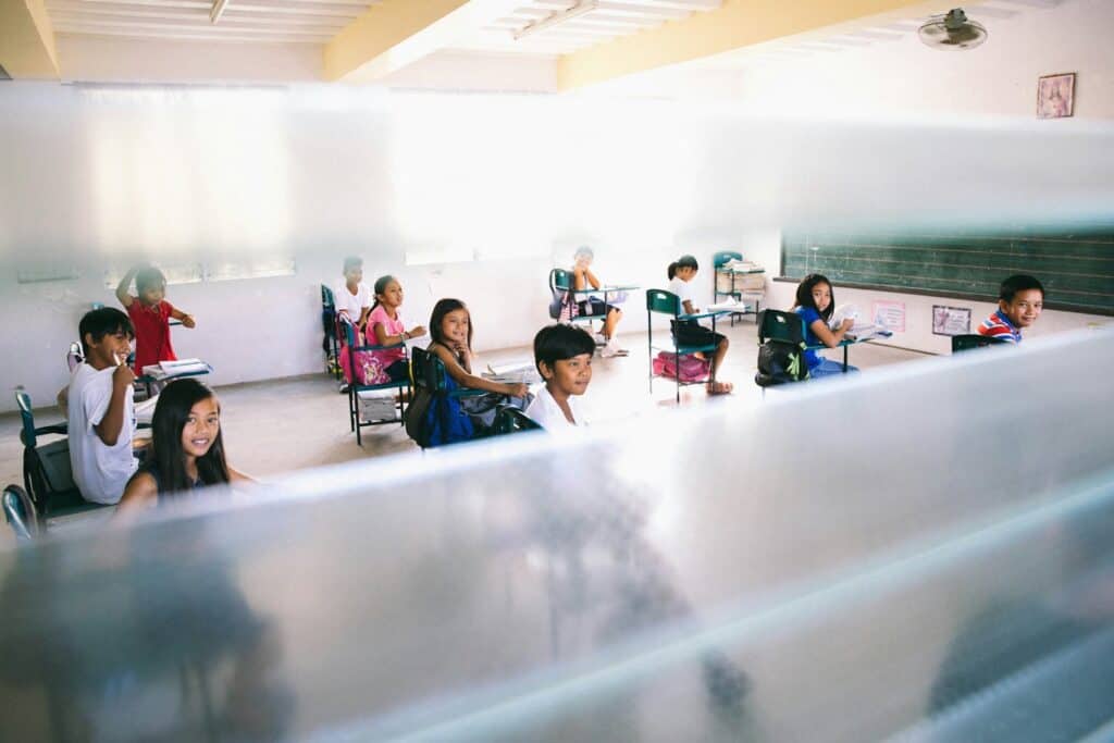 Students sitting at desks in a school classroom