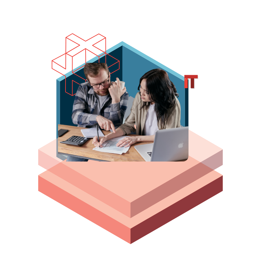 Two professionals reviewing documents at a desk with a laptop and calculator, inside a blue polygonal workspace with abstract red IT shapes in the background.