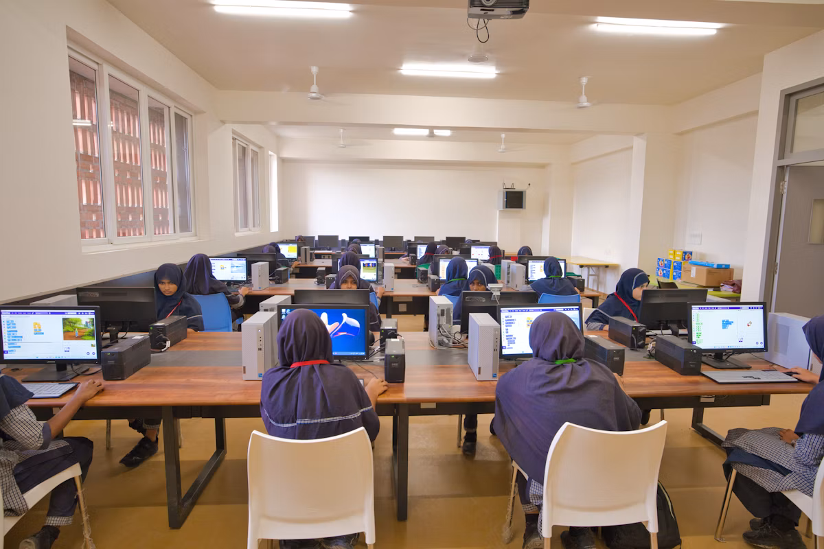 Students working at computers in a bright school computer lab