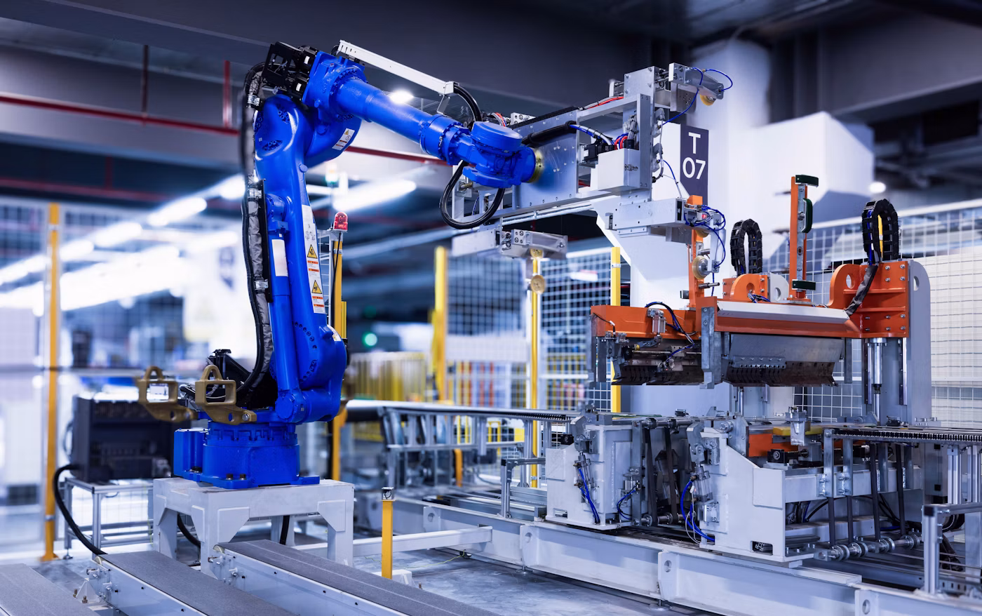 Blue industrial robot arm working on a factory production line