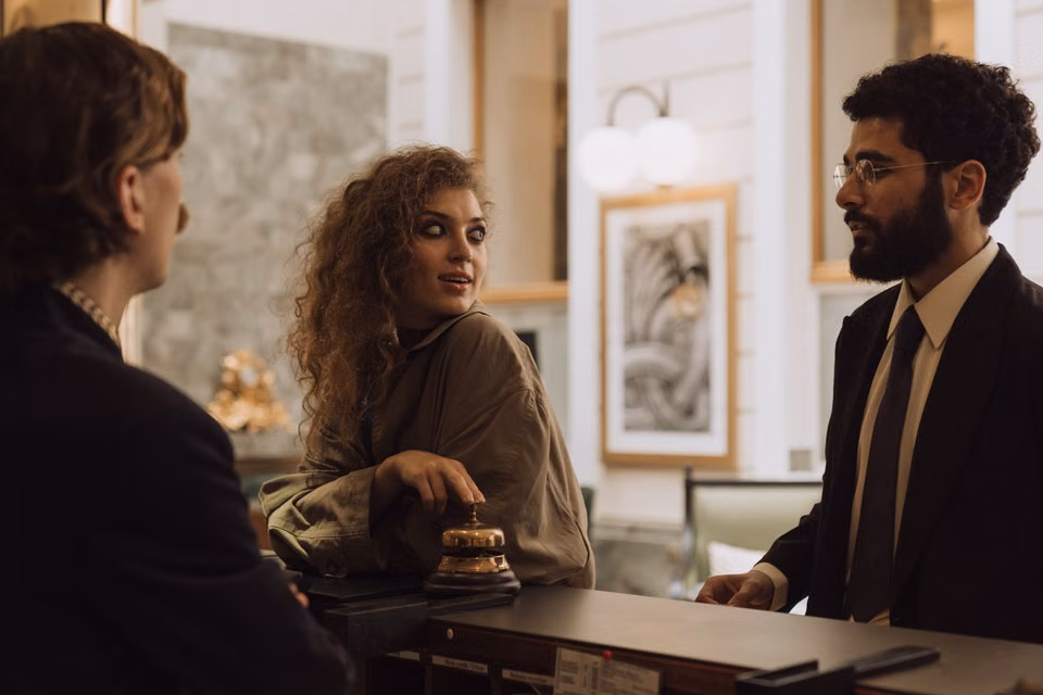 Guests checking in at a hotel reception desk