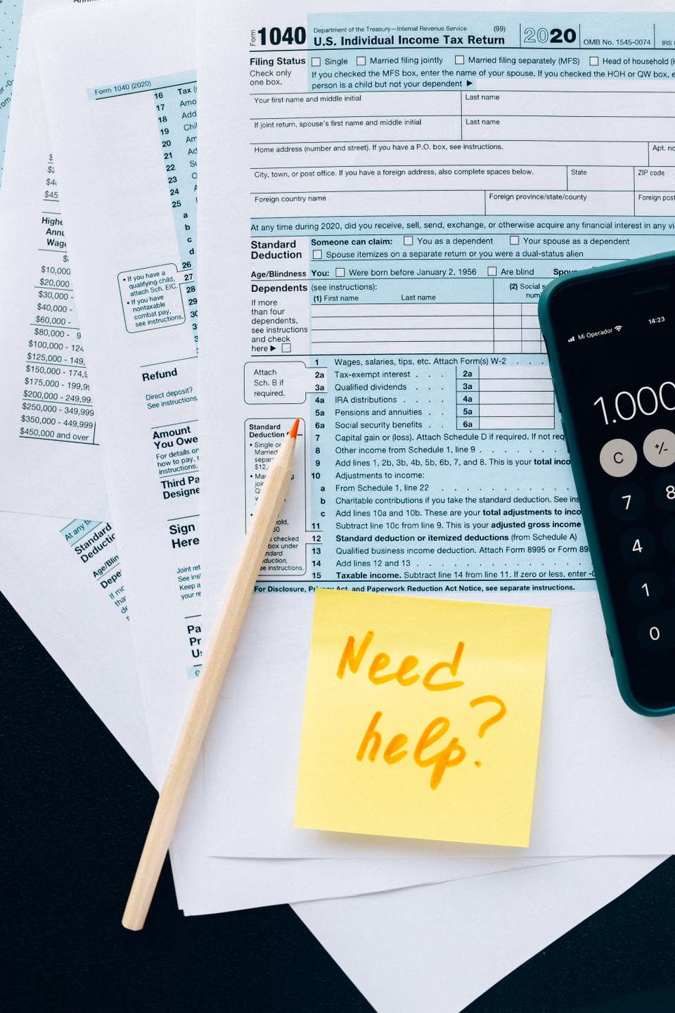 Tax forms on a desk with a calculator