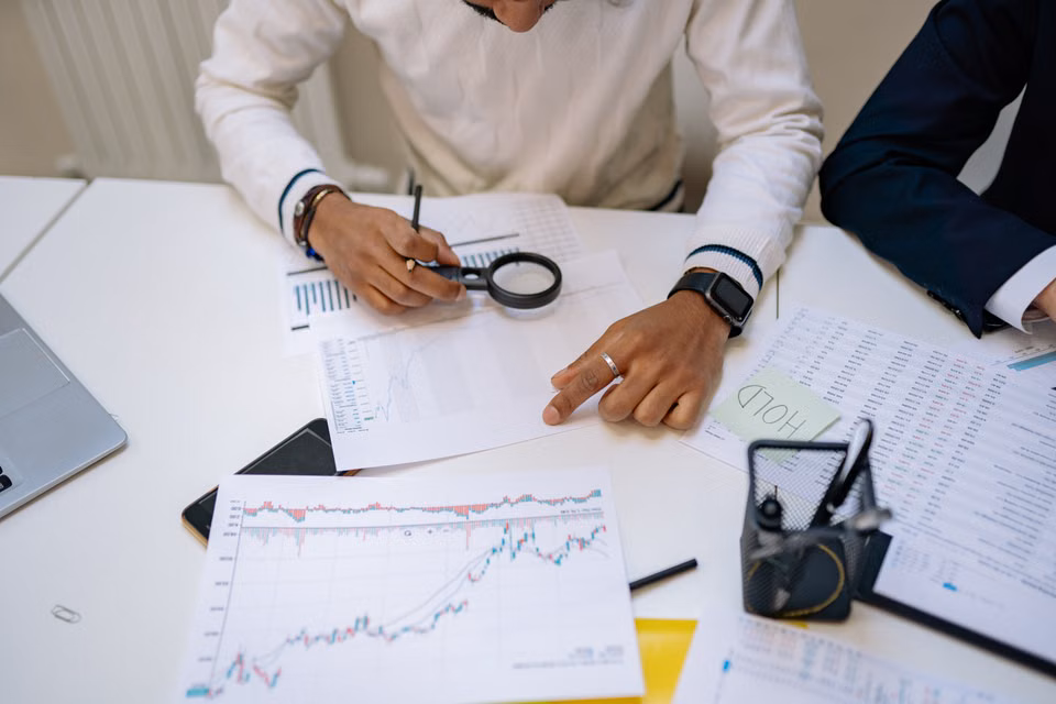 Professionals reviewing financial charts in an office