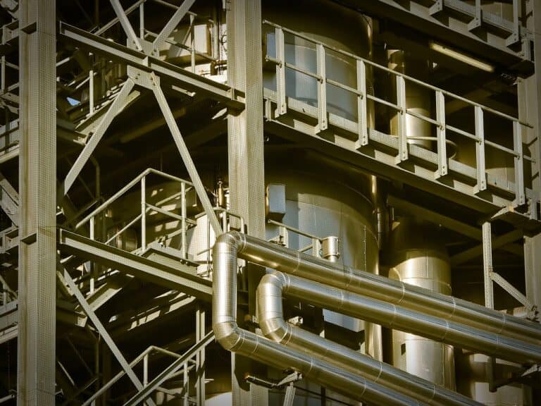 Close up view of a green and silver metal tinted manufacturing plant