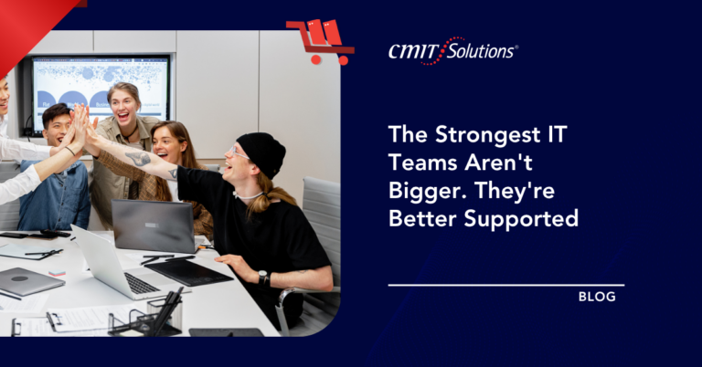 Diverse team high-fiving around a laptop-filled conference table in a bright office; right side shows CMIT Solutions branding and a blog headline on a dark blue panel.