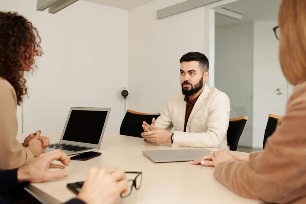 A team of coworkers meets to discuss ways they can grow and scale the IT at their business.