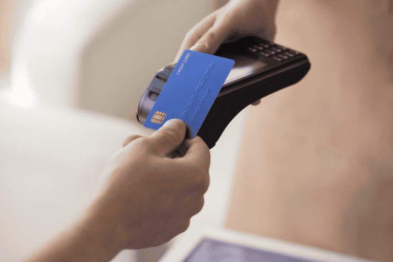 Someone uses a credit card on a card reader.