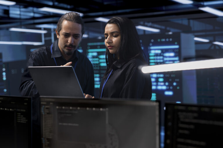 coworkers in data center doing routine disk checks