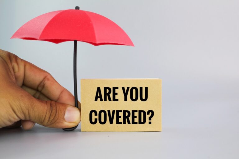 hand holding an umbrella with the question are you covered