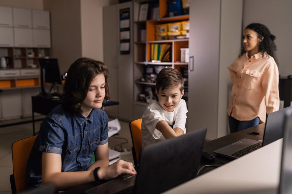 Students using laptops in a classroom
