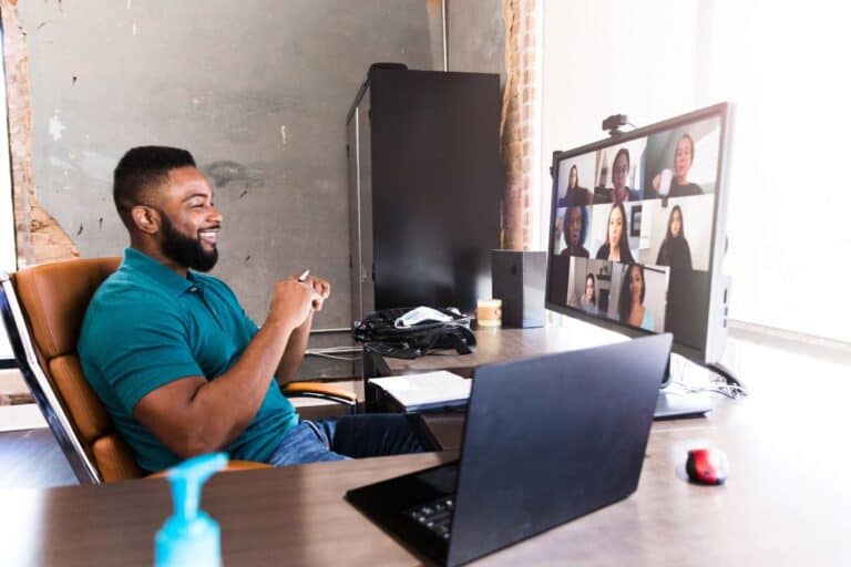 Cheerful businessman video chats with colleagues