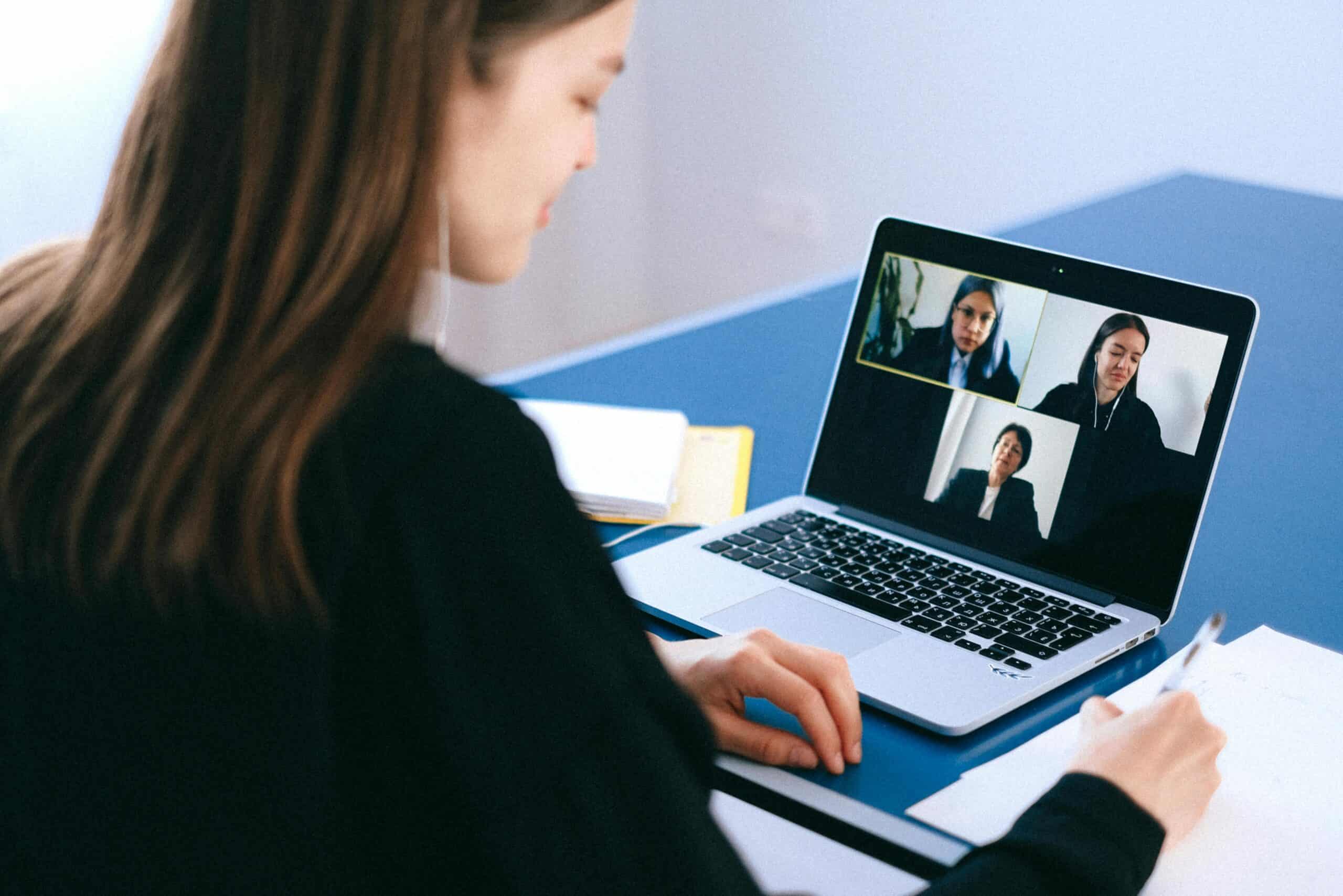 A business owner holds a meeting with remote workers.