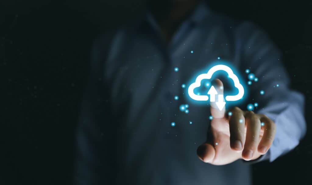 A business owner touches a cloud symbol, depicting the use of cloud services in his business.