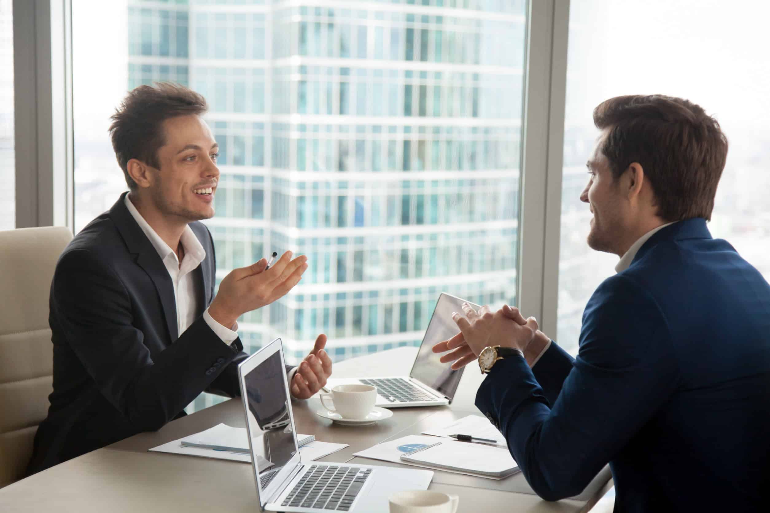 A business owner meets with an IT specialist to discuss cybersecurity measures for his SMB.