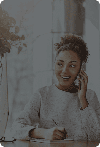 IT Support for Law Firms in South Denver Young gal on cellphone writing something in notebook