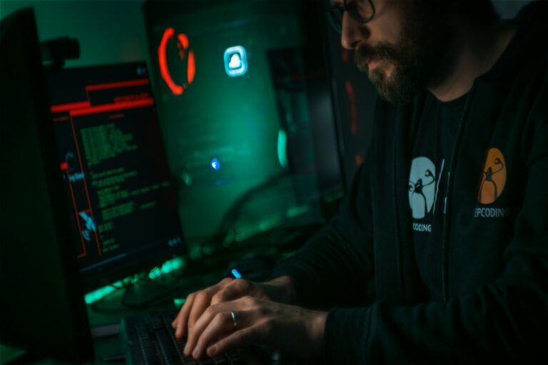 man typing on computer