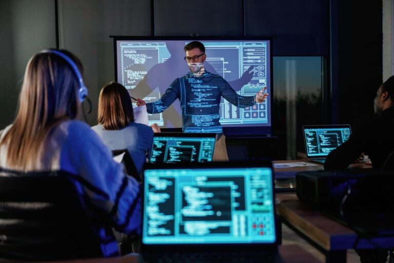 Business coach giving presentation to coding students