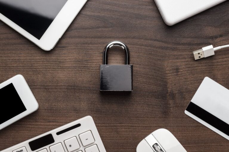 Padlock surrounded by tech devices and credit card
