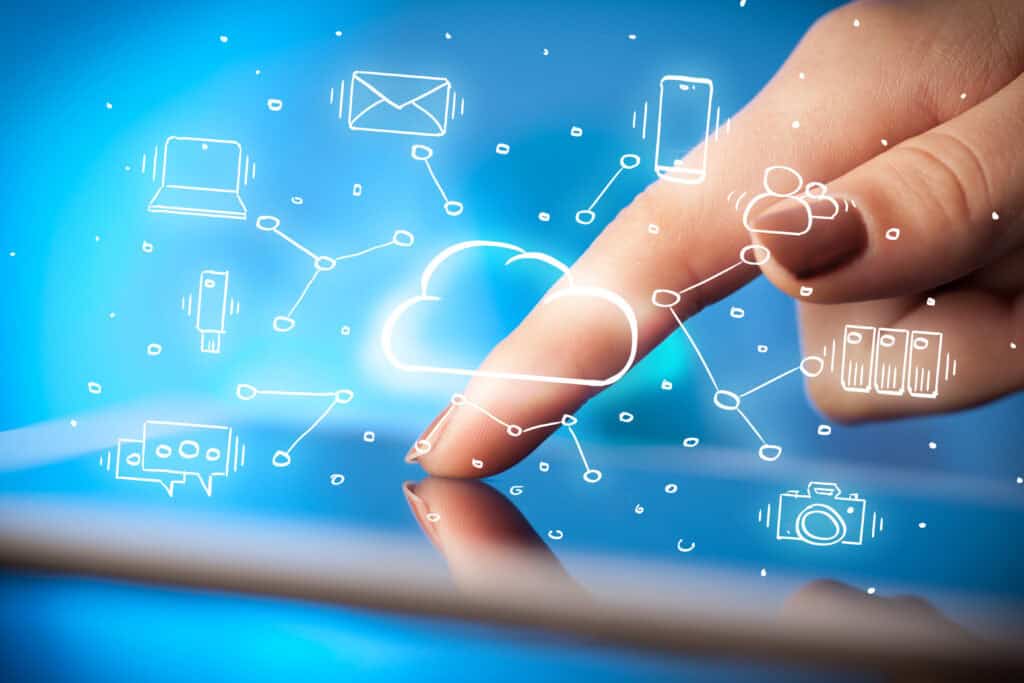 Illustration of a hand working on a tablet with icons of cloud technology surrounding it.