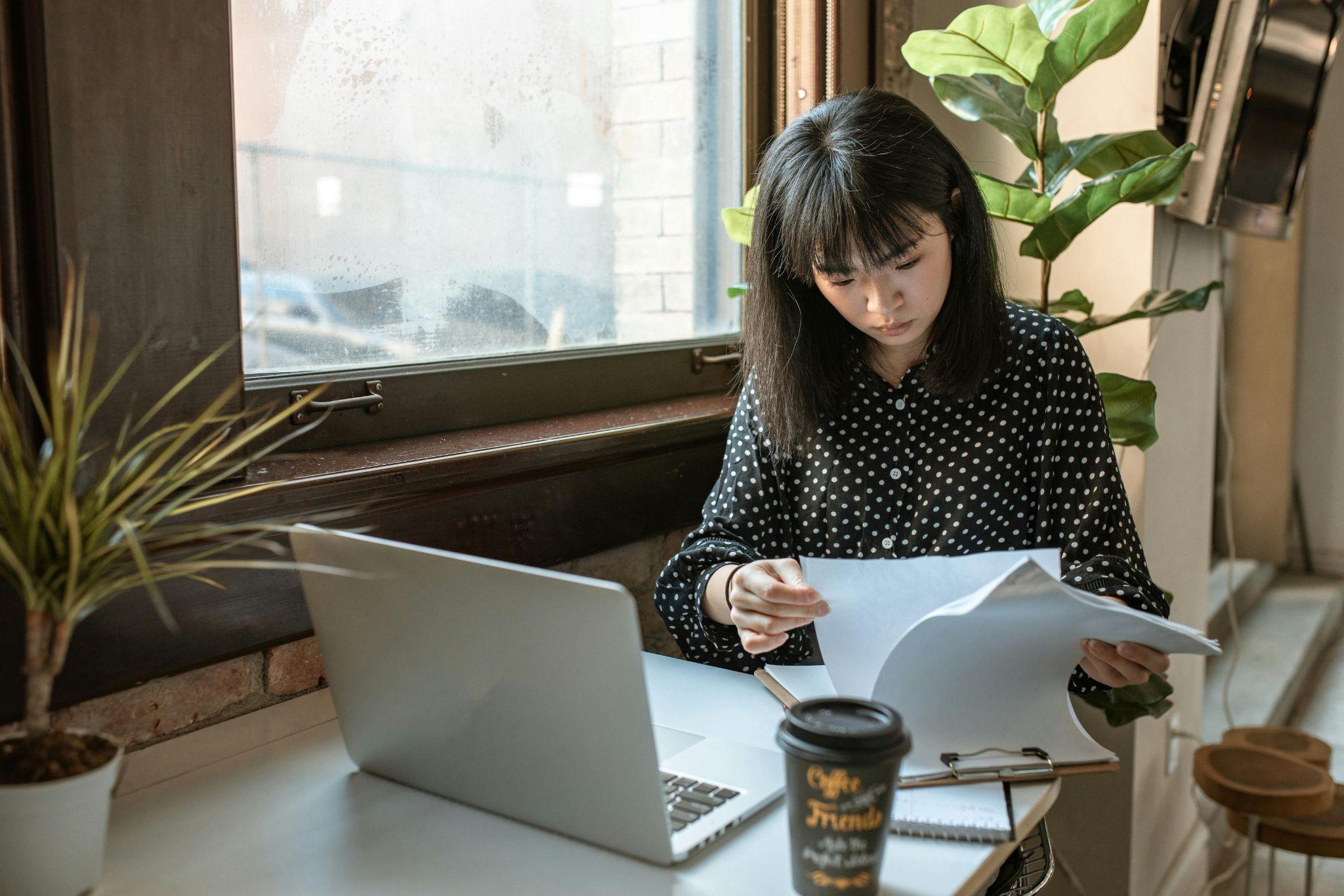 A focused person working on a laptop in a secure office environment, representing internal data security protocols