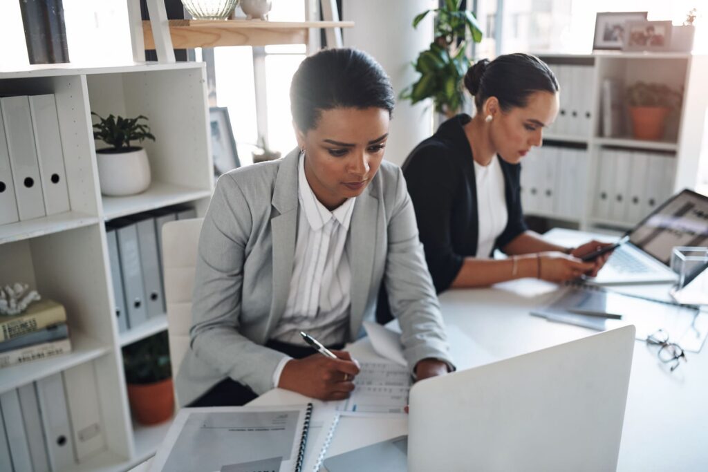 cropped-shot-of-two-attractive-young-businesswomen