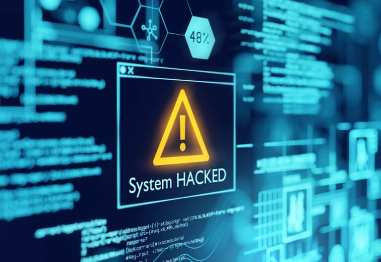 Computer screen with warning alert saying system was hacked by cyberattack