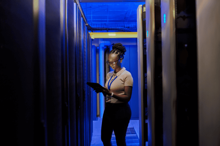 Shot of a young female engineer using a digital tablet while working in a server room