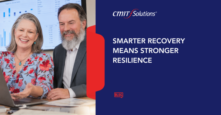 Two professionals, a smiling woman in a floral blouse and a bearded man in a suit, review charts on a screen beside CMIT Solutions branding and the headline 'Smarter Recovery Means Stronger Resilience'. (Informative blog hero)