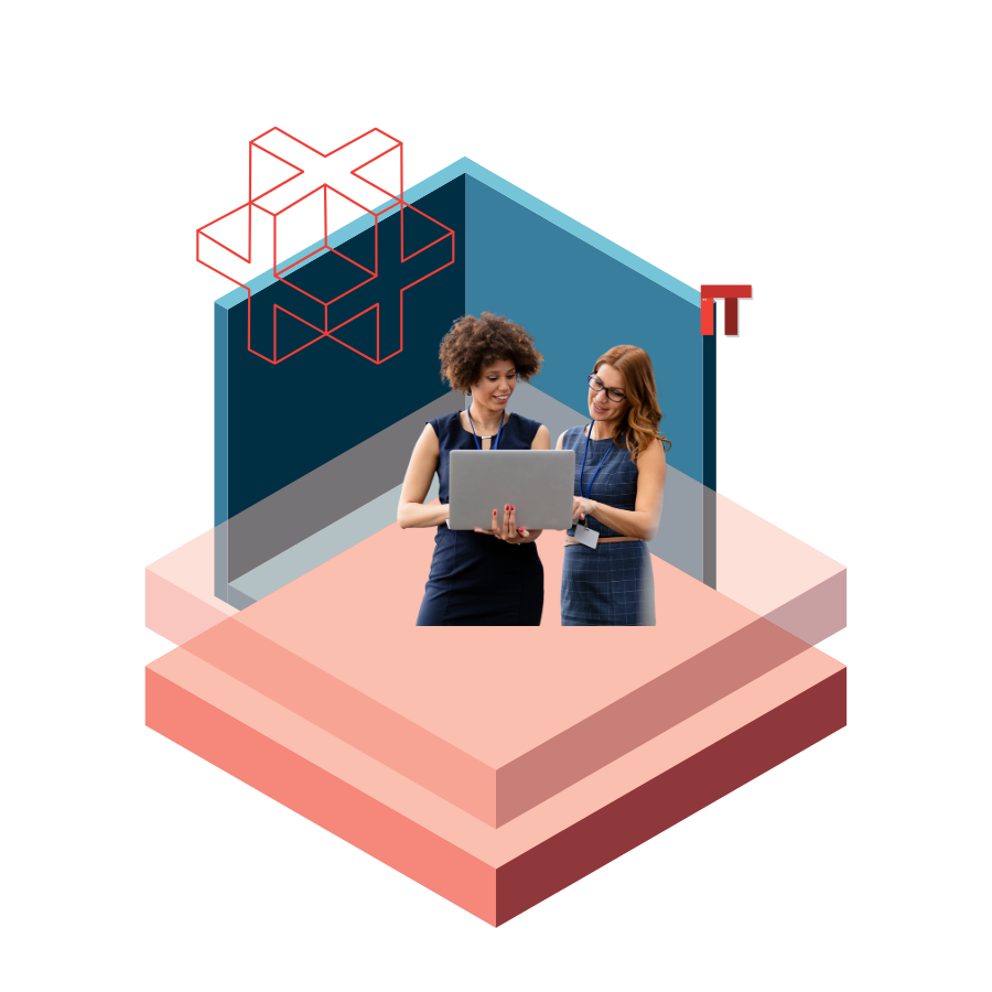 Two women collaborating with a laptop inside a blue geometric stage with an IT label nearby.
