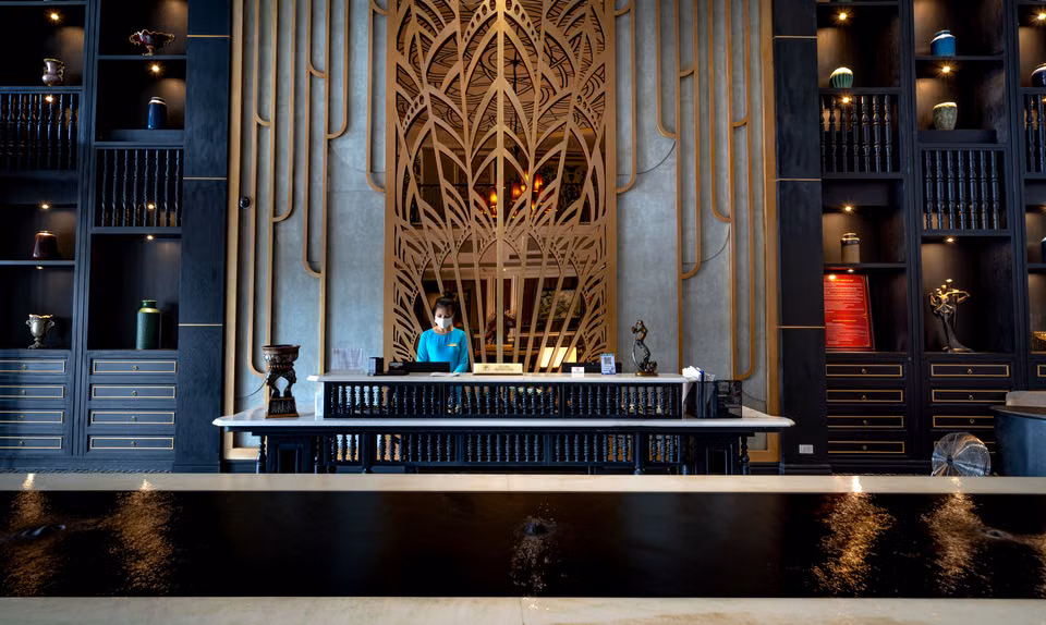 Hotel front desk with a receptionist