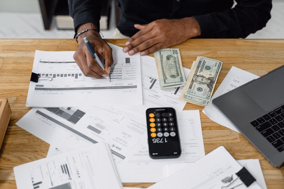 Accountant working on tax documents with a calculator