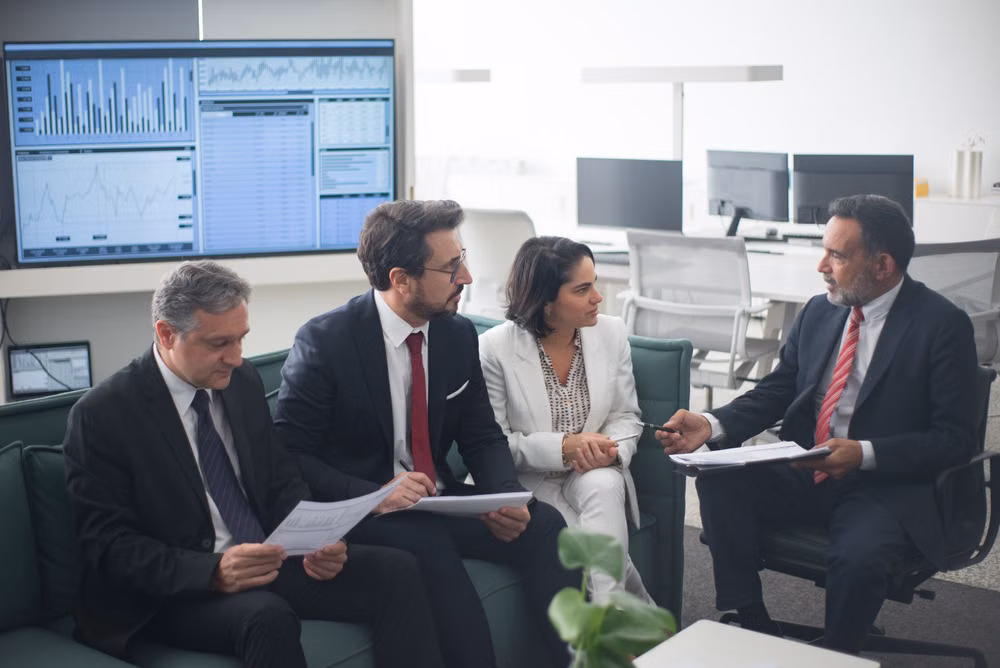Finance team reviewing reports in a modern office
