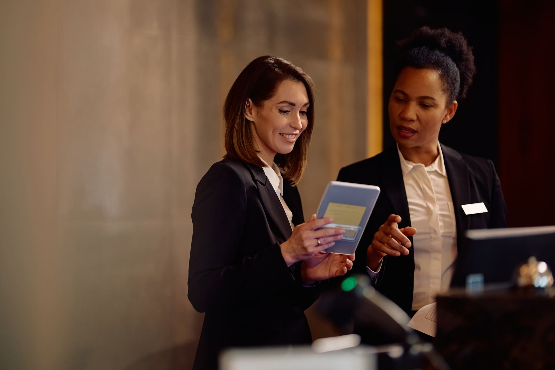female-hotel-receptionists-using-digital-tablet