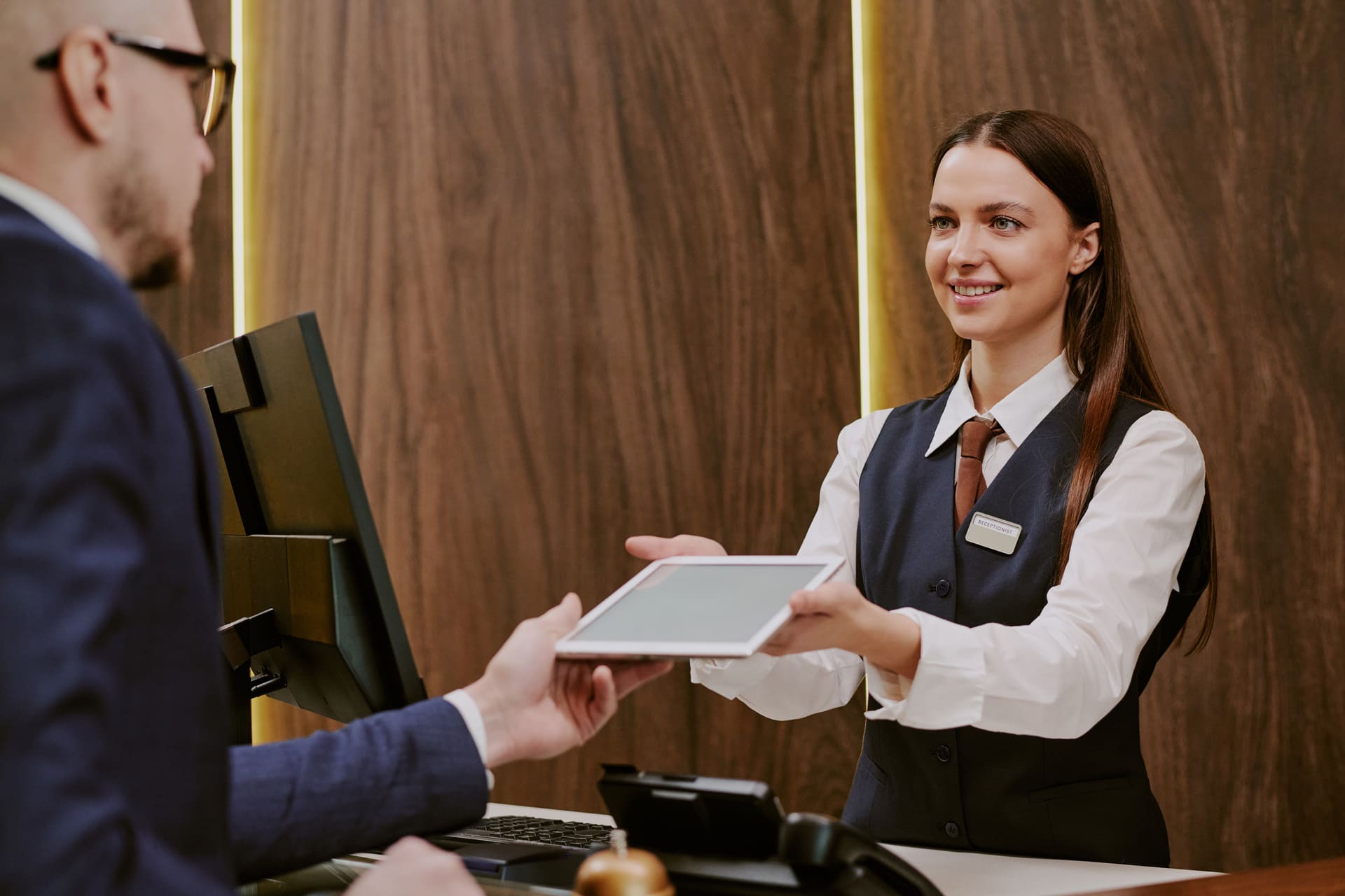 receptionist-giving-tablet-to-hotel-guest