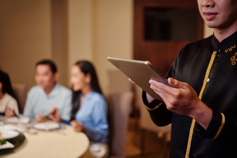 waiter-taking-order-on-tablet-in-restaurant