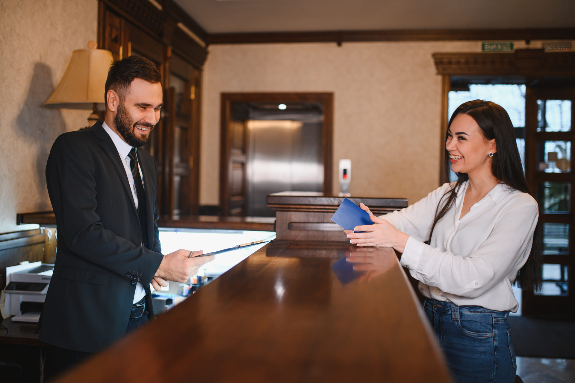 woman-checking-into-a-hotel-lobby-with-concierge
