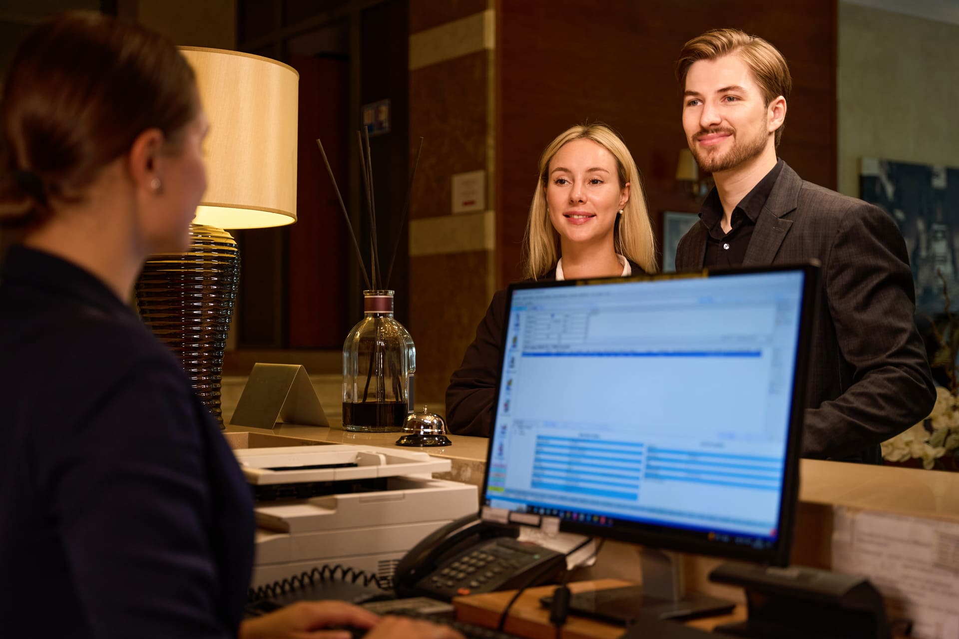 hotel-guests-checking-in-at-front-desk