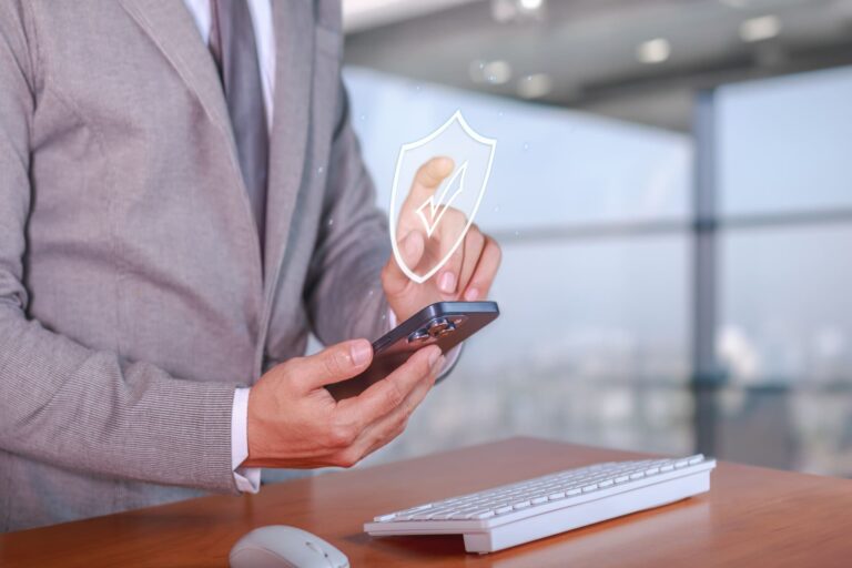Person touching a digital security shield icon on a smartphone